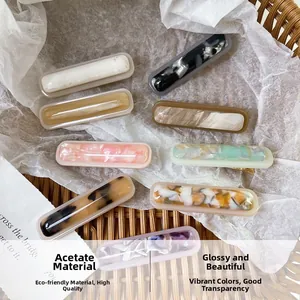Detailed close-up of colorful acetate hair clips in various marble and tortoiseshell patterns