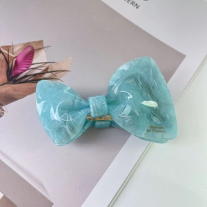 Detail of marbled blue acetate hair claw clip with gold Barrette La France lettering