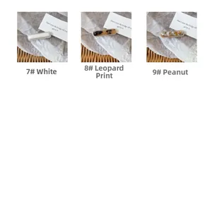 Close-up of acetate side hair clips in white, leopard print, and amber marble textures