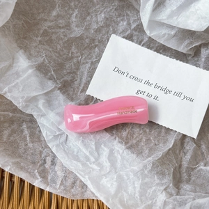 Detailed macro of pink wavy marble hair clip with gold France Handmade lettering