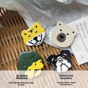 Detailed macro of shiny acetate hair clips featuring cartoon tiger and animal designs