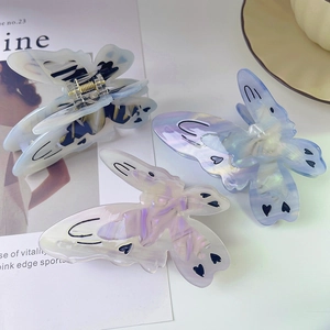 Three gradient acetate butterfly hair claws with marble texture and heart patterns
