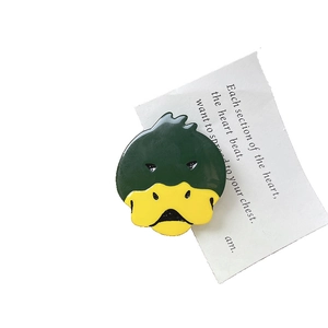 Cute cartoon duck acetate hair clip in green and yellow with a unique quirky facial expression