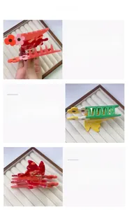 Detailed views of acetate floral claw clips in red and yellow with metal spring design