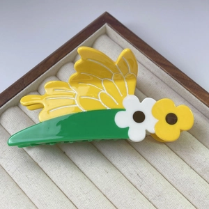 Chic acetate bee and flower hair claw clip in a luxury jewelry display box