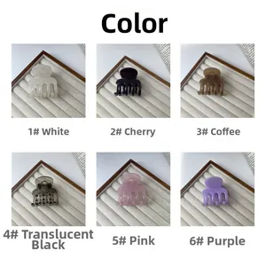 Showcase of six colorful acrylic hair claws on a velvet display stand in various shades