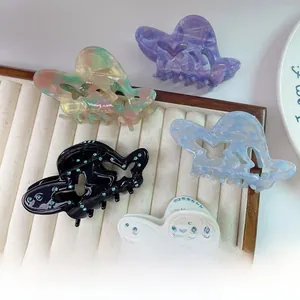 Detail view of five assorted butterfly acetate hair claws with sparkling rhinestones set