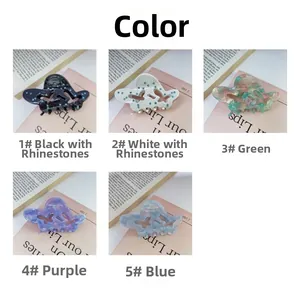 Detail view of five assorted acetate butterfly hair claws with rhinestone embellishments