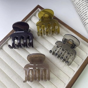 Set of four glossy French style resin hair claws in black olive grey and brown finishes