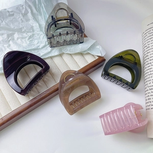 Large hollow claw clips for women in translucent resin colors like amber and green
