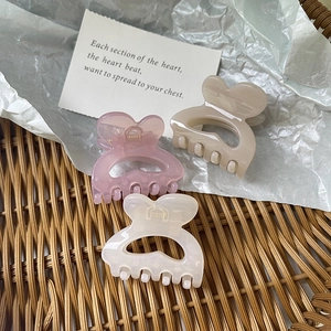 Cute heart-shaped hair claw clips set in pink, cream and beige colors for women