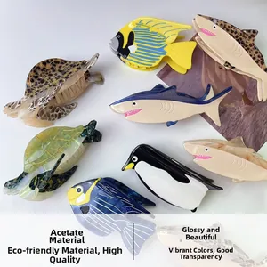 Macro detail showing diverse ocean-themed acetate hair claws with premium glossy textures