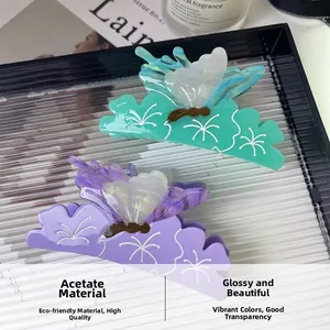 Close-up of elegant purple and green butterfly hair claws made of high-quality acetate material