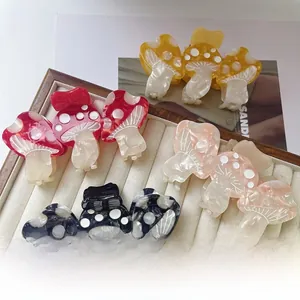 Detailed view of colorful mushroom acetate hair claws arranged on a jewelry tray