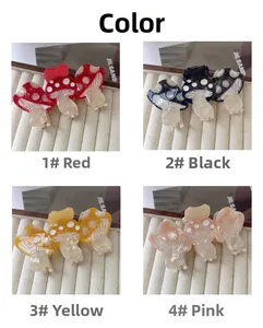 Detail view of colorful mushroom claw clips in four colors with acetate polka dot patterns