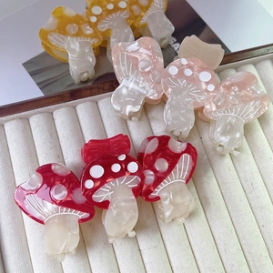 Cute mushroom-shaped acetate hair claws in red, pink and yellow with marble texture
