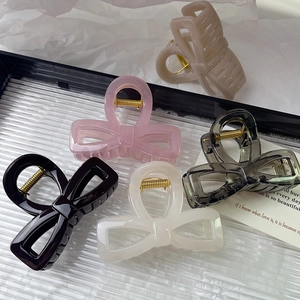 Elegant acrylic bow hair claws in five colors featuring durable golden metal springs
