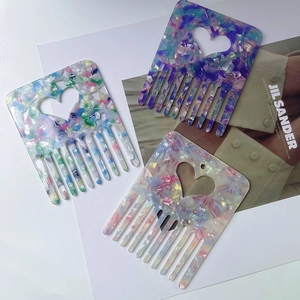 Three-piece heart-shaped acetate hair combs with marble patterns in purple, pink and multi-color