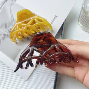 French style amber and yellow hollow hair claw clips on a stylish fashion book