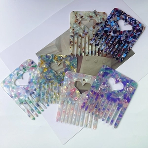 Chic acetate hair combs with heart cutout in various colorful marble patterns