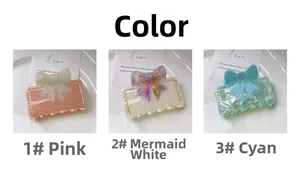 Vue détaillée des pinces à cheveux nœud en rose, blanc nacré et vert marbre avec strass
