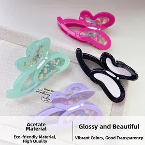 Close-up of butterfly hair claws in acetate with glossy marble finish and colors