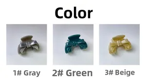 Trois pinces à cheveux à nœuds en gris, vert et beige sur un fond gris clair