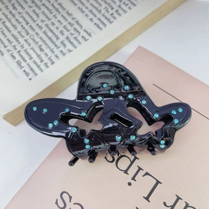 Molla per capelli a farfalla in acetato nero con strass blu e cuore traforato