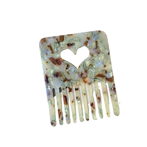 Elegant acetate heart cutout hair comb with colorful marble pattern and wide teeth