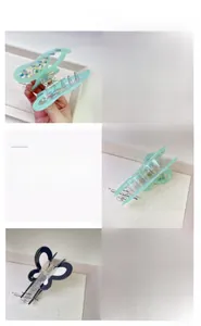 Detail view of butterfly hair claw clip with colorful polka dots and two-tone acetate finish