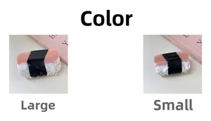 Detail showing two sizes of color-block acetate hair claws in pink and marble white