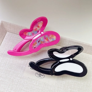 Elegant butterfly acetate hair claws in vivid fuchsia floral and classic black white patterns