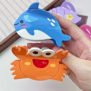 Close-up of colorful ocean animal hair claws including dolphins and crabs