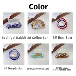 Flat lay of six colorful acetate hair claws featuring swan, rabbit and star designs