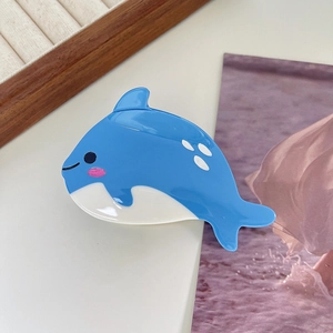 Detail of creative sky blue and cream whale hair claw clip with a glossy finish