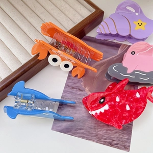 Cartoon ocean animal hair claws including pink dolphin and blue shark shaped clips
