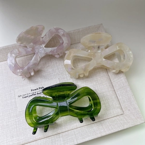 Three-piece set of elegant acetate bow hair claws in pink, cream, and green marble