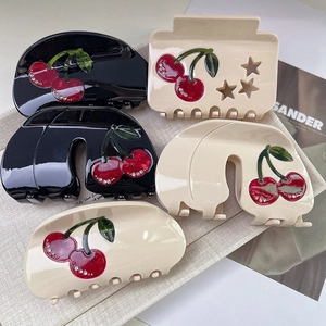 Five-piece cherry hair claw set with rhinestones and star cutouts in beige and black