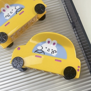 Cute yellow car hair claw clip with cartoon bunny design made of glossy acetate material