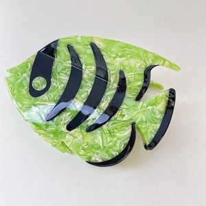 Close-up of green marble acetate fish hair claw clip with black striped tropical pattern