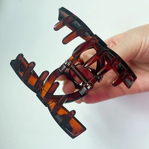 Close-up of durable amber tortoise shell hair claw clip with strong metal spring