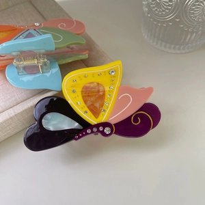 Detailed view of colorful acetate butterfly hair claw clip with sparkling rhinestones decoration