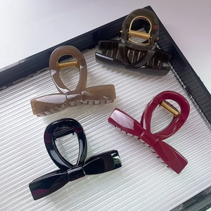 Elegant bow-shaped hair claws in burgundy, black, amber, and green colors set