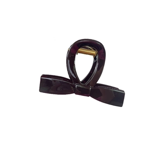 Elegant dark glossy bow-shaped hair claw clip with golden metal spring for women