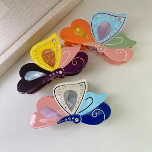 Three colorful acetate butterfly hair claws with rhinestones and marble patterns