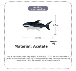 Shark-shaped acetate hair claw clip with black and white design and dimensions 12.5x4.5cm