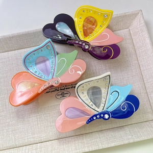 Elegant butterfly hair claw clip with colorful acetate marble pattern and white rhinestones