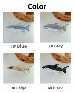 Detail view of acetic acid shark hair claw clips in blue, grey, beige and black colors