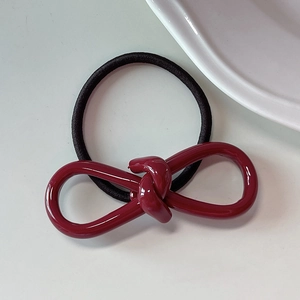 Close-up of a 5mm elastic hair tie with a dark red knotted acetate bow decoration