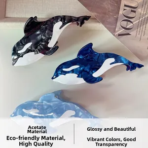 Detailed texture of acetate whale hair claws in black and blue with glossy marble finish